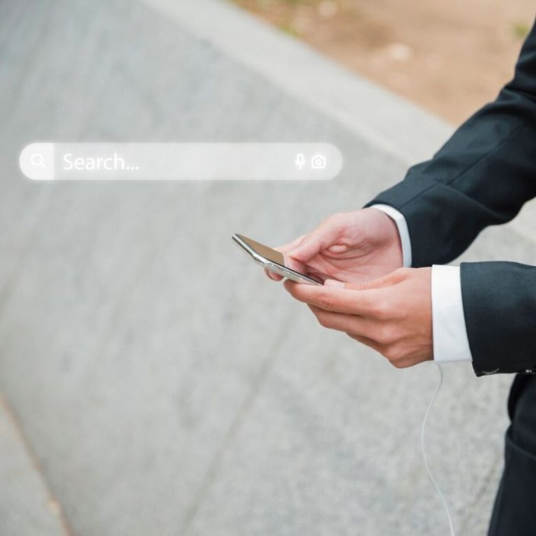 man holding cell phone with search bar